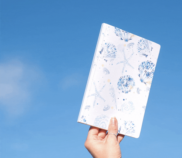 Blue seashell notebook with luxury linen cover and 128 lined pages.