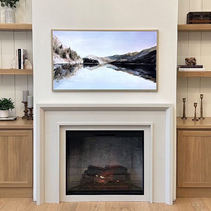 Fireplace under a framed landscape painting.
