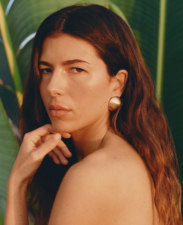 Close up of woman wearing gold earring