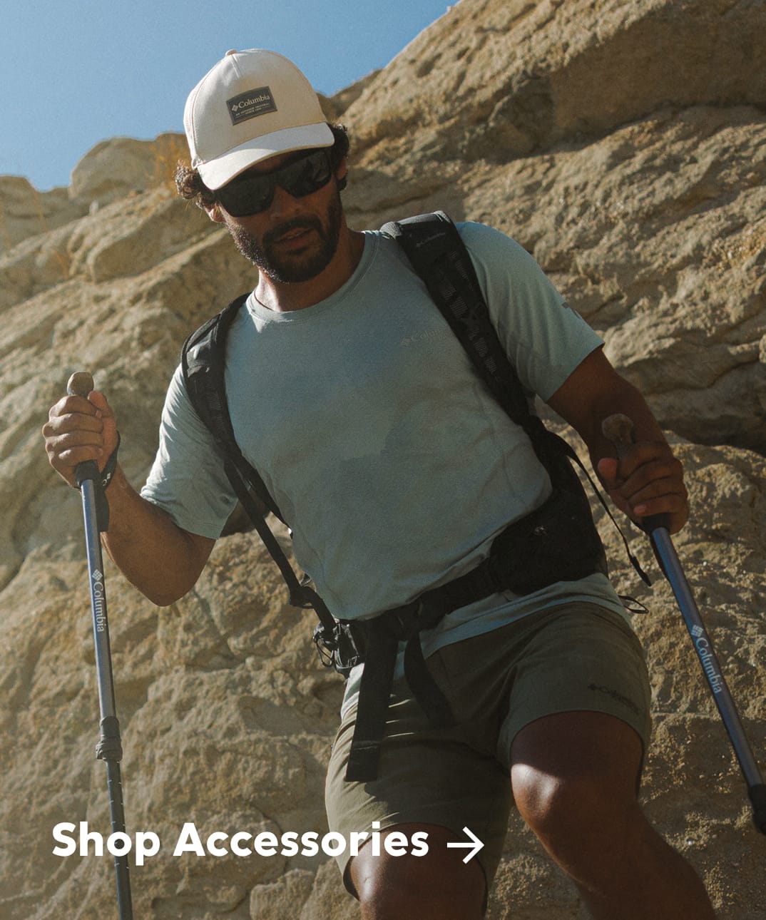 A man in hiking gear in a rocky landscape with text: Shop Accessories