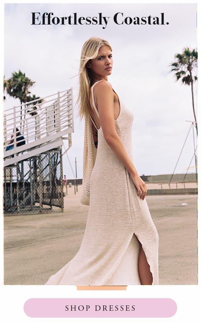 model wearing a gold knit maxi dress with a slit. shop dresses. 