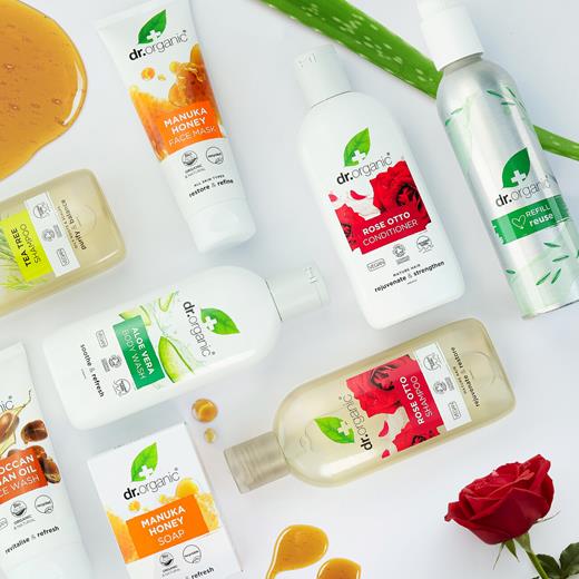 A selection of Dr Organic skincare and personal care products, including creams, lotions and body wash displayed with botanicals.