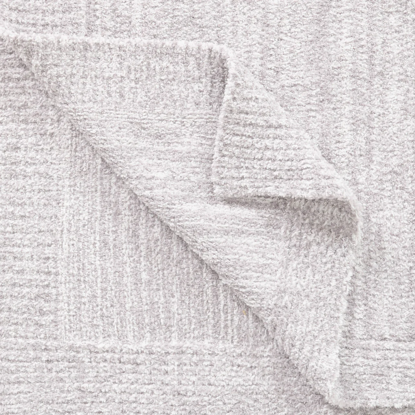 Close-up of a lightweight Kashwére throw in heathered soapstone, steel, and creme stripes, highlighting its soft woven texture and folded edge.