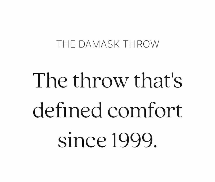 Centered text reads: "The Damask Throw. The throw that's defined comfort since 1999."