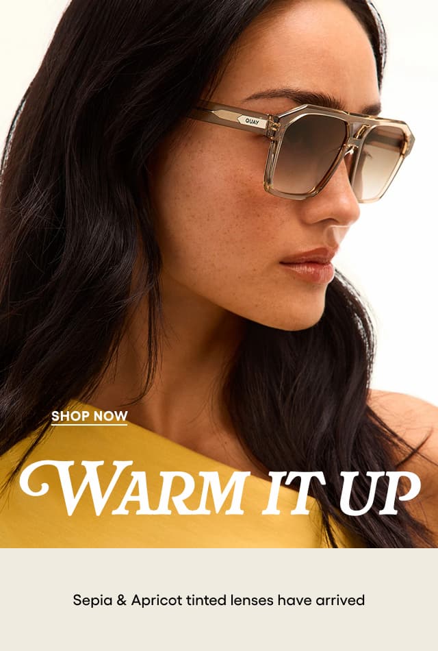 Image of woman wearing yellow top and large tan shield sunglasses looking to the side. Shop Now. WARM IT UP. Sepia & Apricot tinted lenses have arrived.