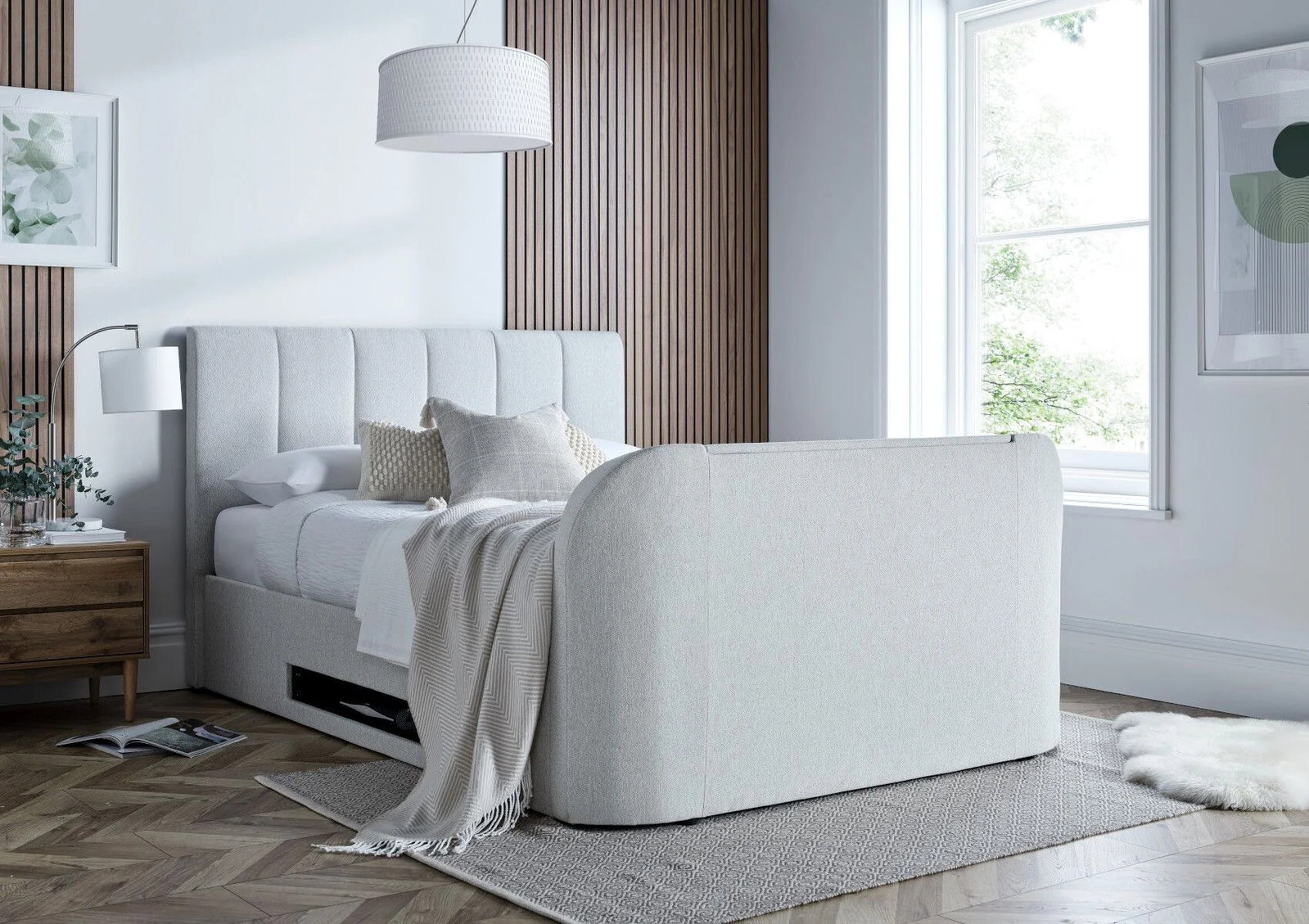 A white fabric bed with white and grey bedding.