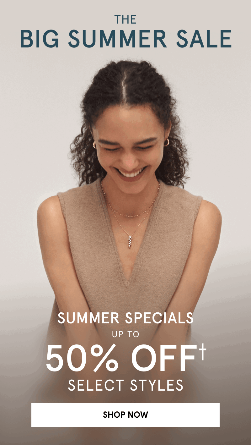 A model wearing layered gold necklaces, including a diamond pendant necklace, and gold earrings. Summer special. Click shop now.