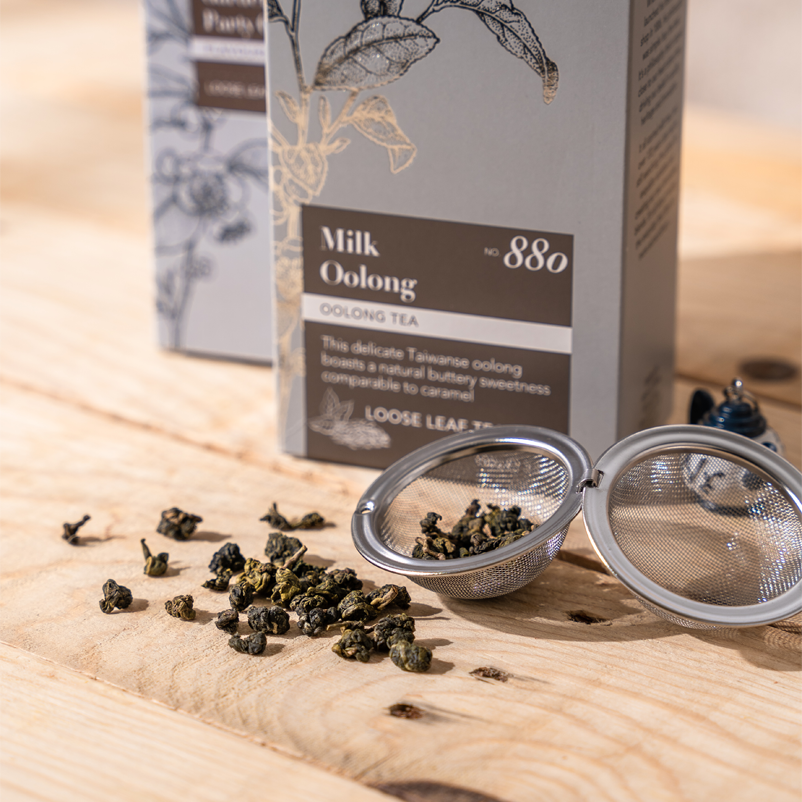image of milk oolong pouch and loose leaf in mug infuser