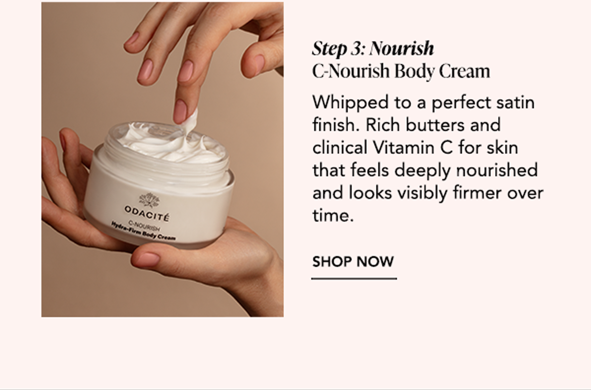 Hands holding an open jar of C-Nourish Body Cream, a rich whipped moisturizer formulated with Vitamin C and nourishing butters.