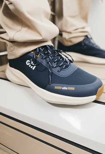 Blue trainers with water splash from sea