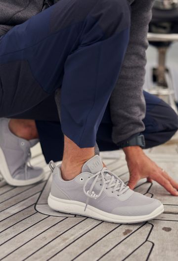 Man knelt down in grey trainers