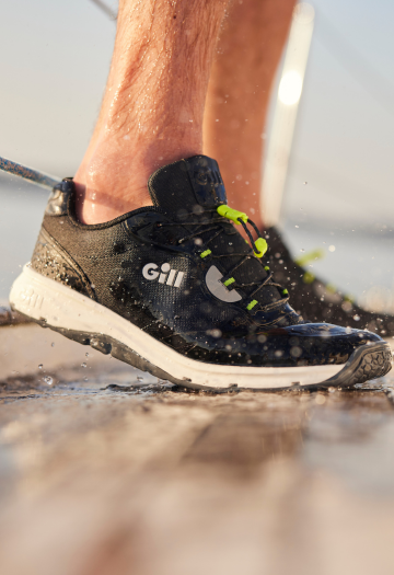 Black trainers on a wet deck