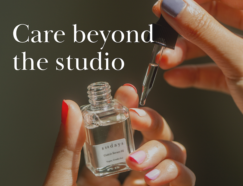 Hand applying cuticle oil at home.