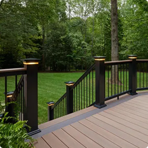 A wooden deck with black railing.