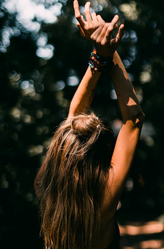 Woman with stretching in a forest