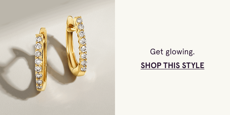 Gold huggies with front face lined with row of close-set diamonds.  Get glowing. Click here to shop this style