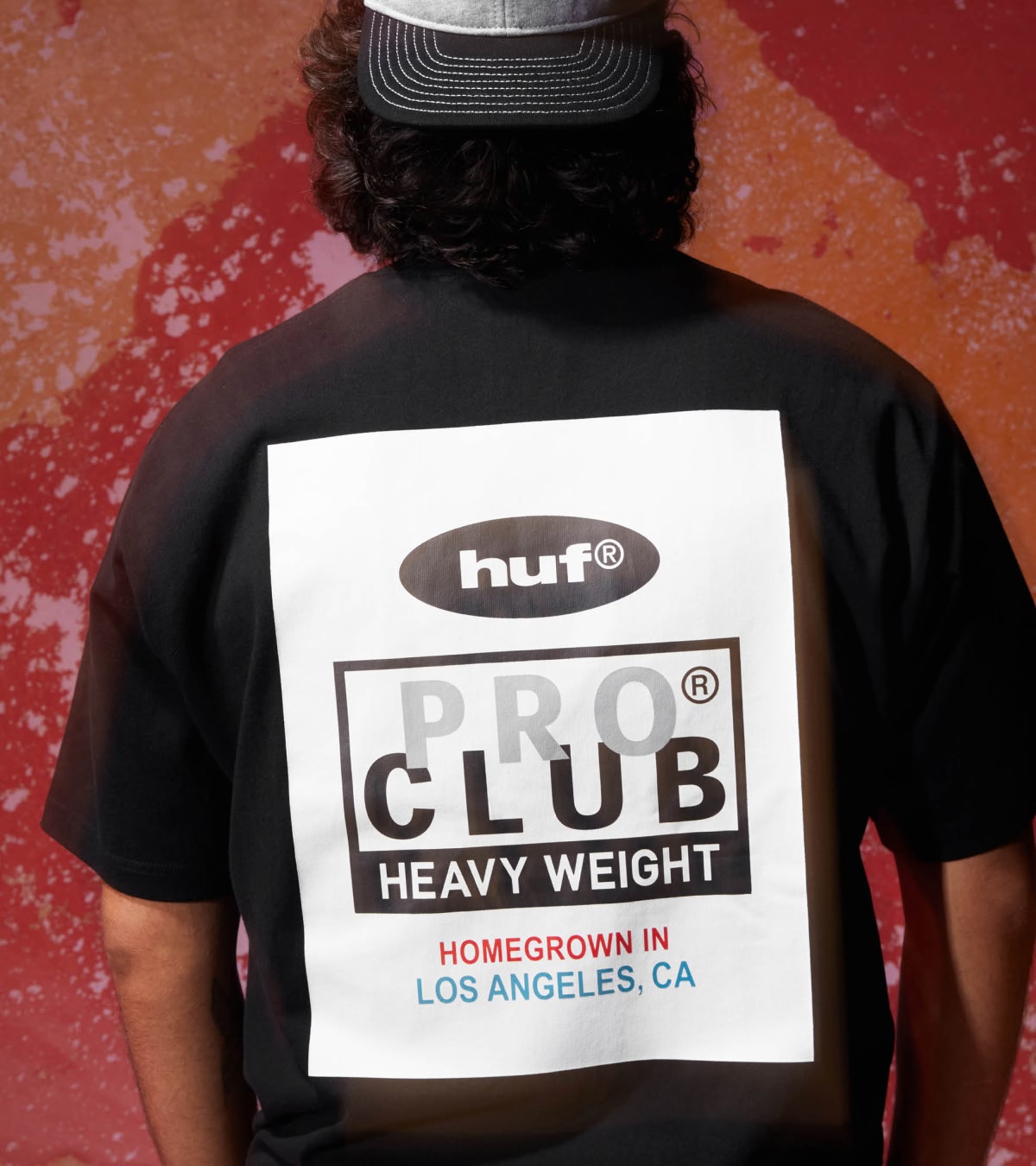 Shop HUF x Pro Club | A person wearing the graphic black tee from the collab