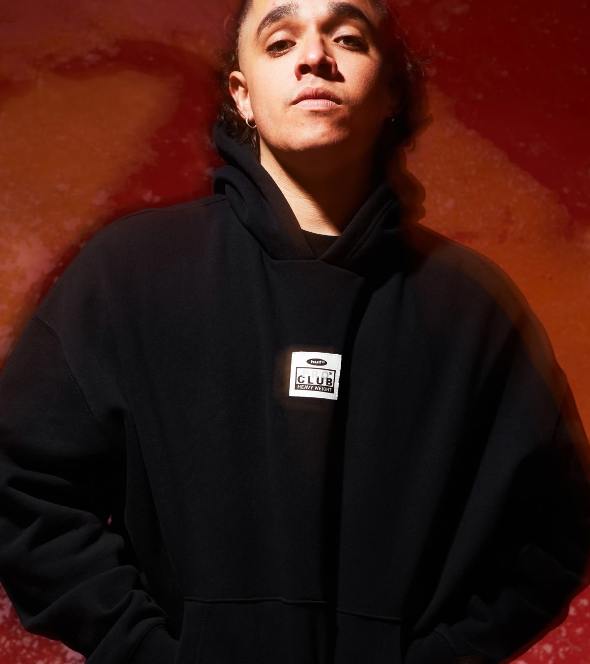 Shop HUF x Pro Club | Front view of a model wearing the heavyweight black hoodie from the collection
