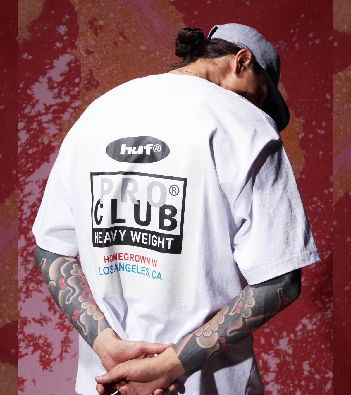 Shop HUF x Pro Club | A person wearing the graphic white tee from the collab