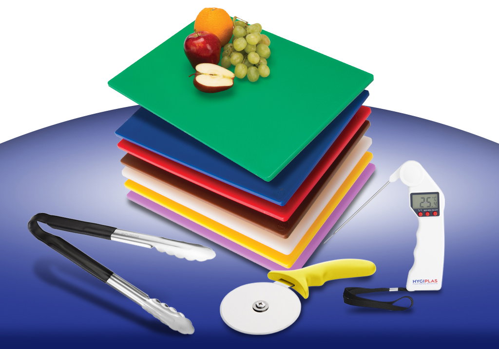 Stack of colour-coded plastic chopping boards with a green board on top holding fruit, displayed with stainless steel tongs, a pizza cutter, and a digital food thermometer on a blue background.