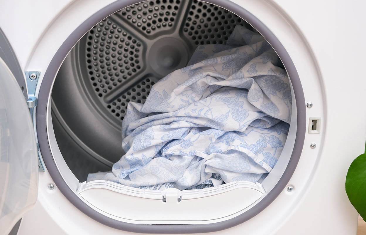 A dryer filled with bedsheets