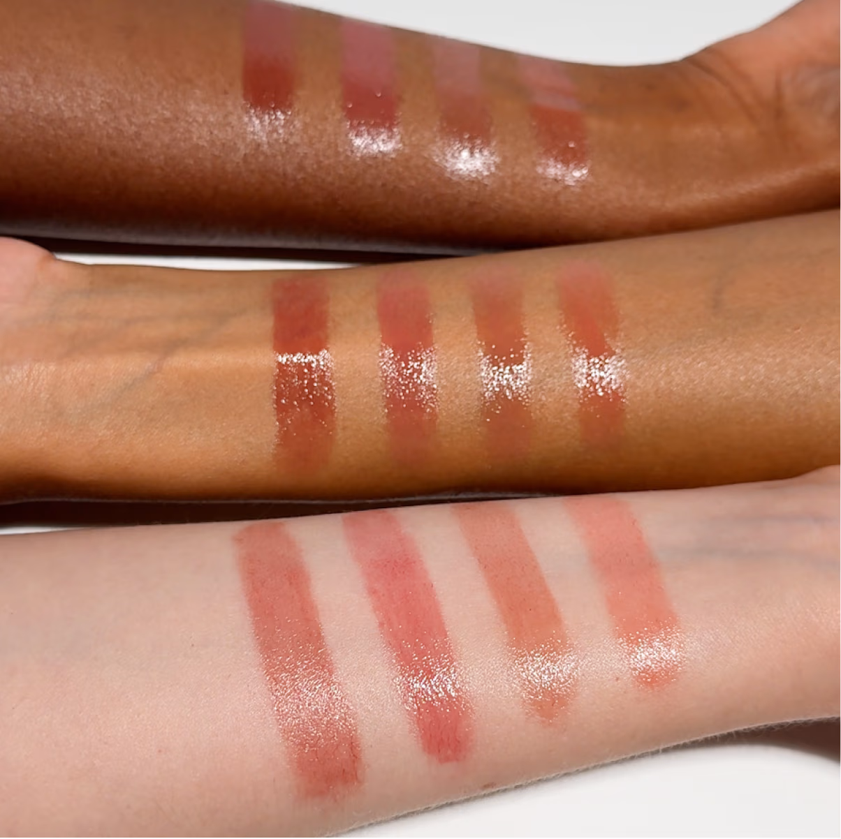 Swatches of Futurelipstick Deluxe Shine on arms