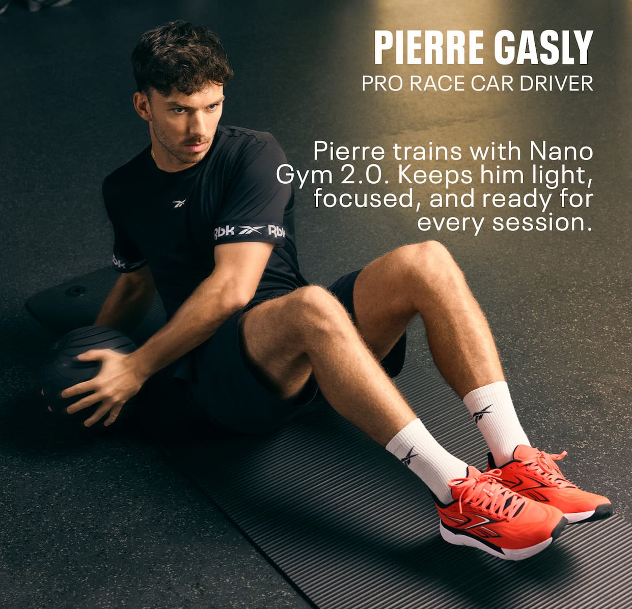 Pierre Gasly trains on a gym mat wearing bright Nano Gym 2.0 training shoes. Text reads: “PIERRE GASLY. PRO RACE CAR DRIVER. Pierre trains with Nano Gym 2.0. Keeps him light, focused, and ready for every session.”