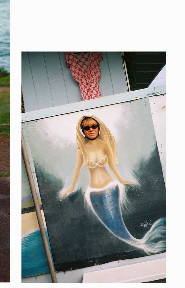 Male surfer posing in a painting of a mermaid