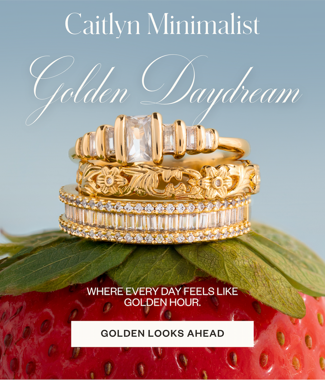 Image of gold stack of rings on top of strawberry with text reading "Golden Daydream, where everyday feels like golden hour"