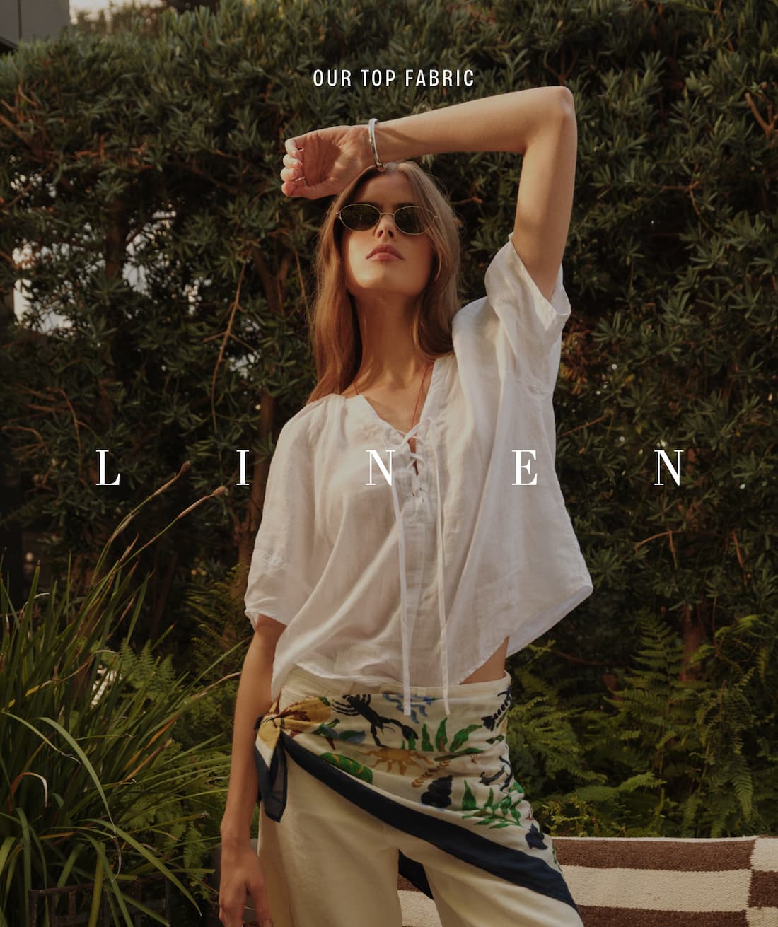 Image shows a model wearing the Livvy Linen Dress in Beach. Text reads: Our Top Fabric. Linen.