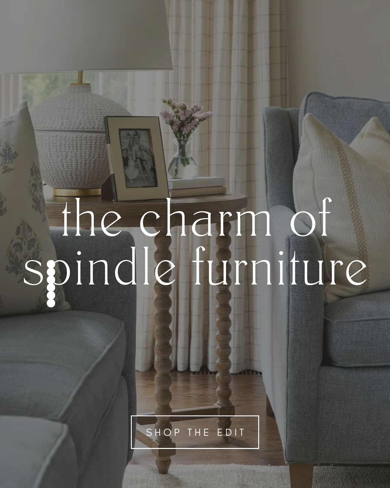 A close up shot of a spindle leg side table in between two sofas.