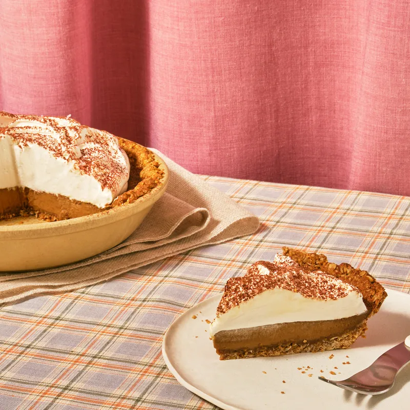 A towering Salted Coffee Custard Pie with a slice cut out