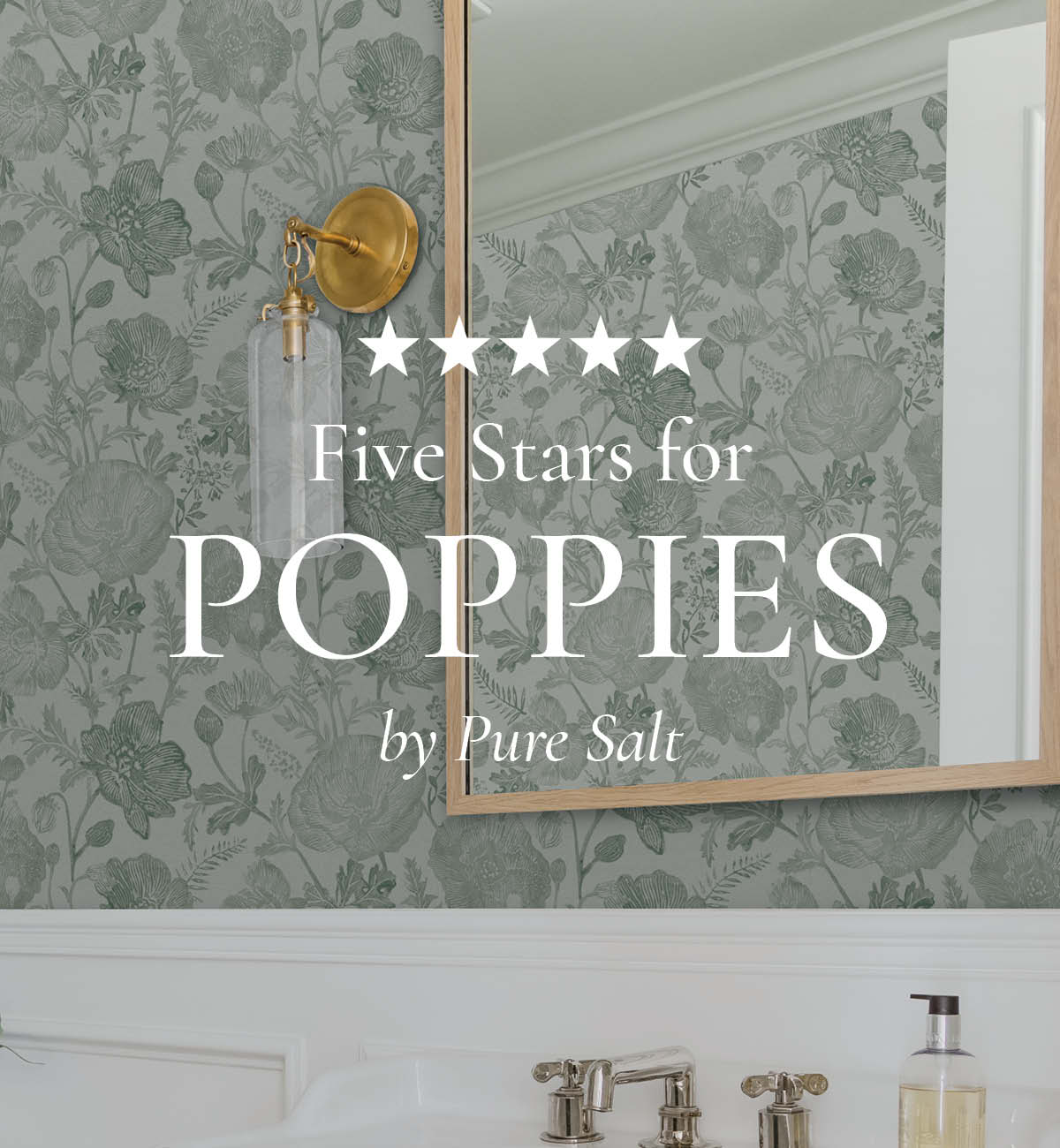 Image of Tempaper's Poppies wallpaper in moss green by Pure Salt installed in a bathroom with a gold trimmed mirror and gold & glass sconce. Text overlayed "Five Stars for Poppies by Pure Salt"