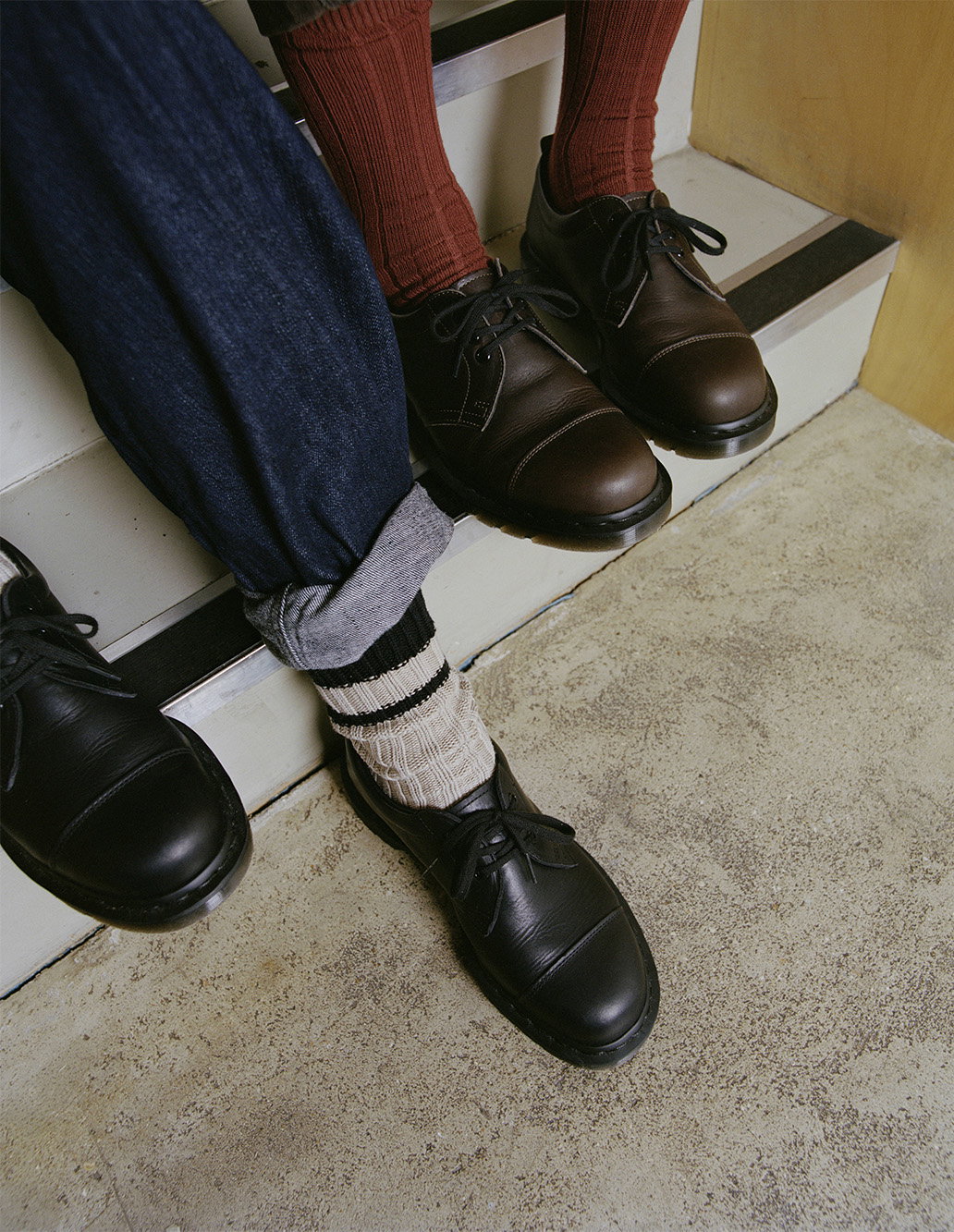 Dr. Martens for MHL. shoes worn with rolled denim trousers.
