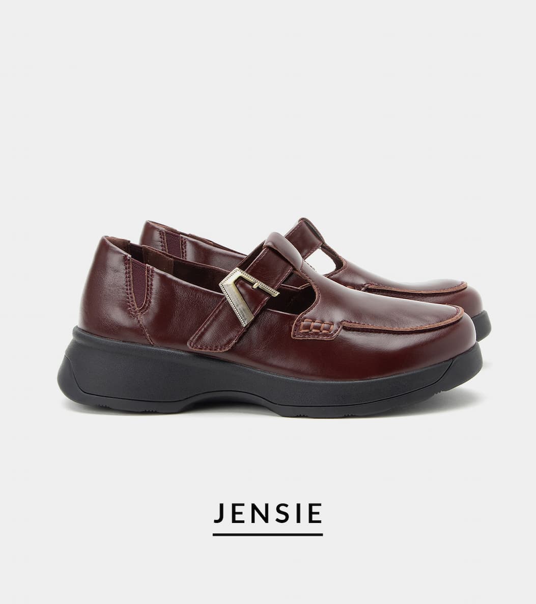 Side view of the Alegria Jensie leather Mary Jane shoe in rich burgundy with an adjustable buckle strap, moc-toe stitching, elastic side gore, and a black supportive platform outsole.