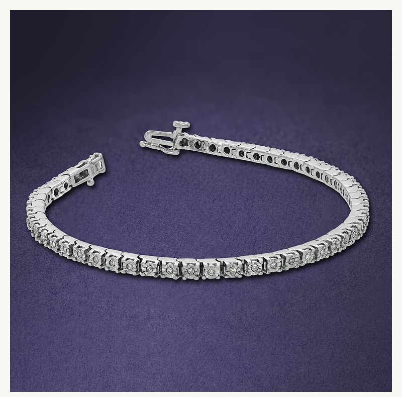 Silver-set tennis bracelet comprised of circle-cut diamonds.