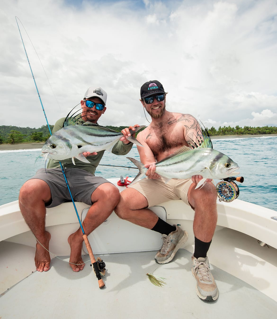 Two PFG ambassadors on a boat holding up their catches.