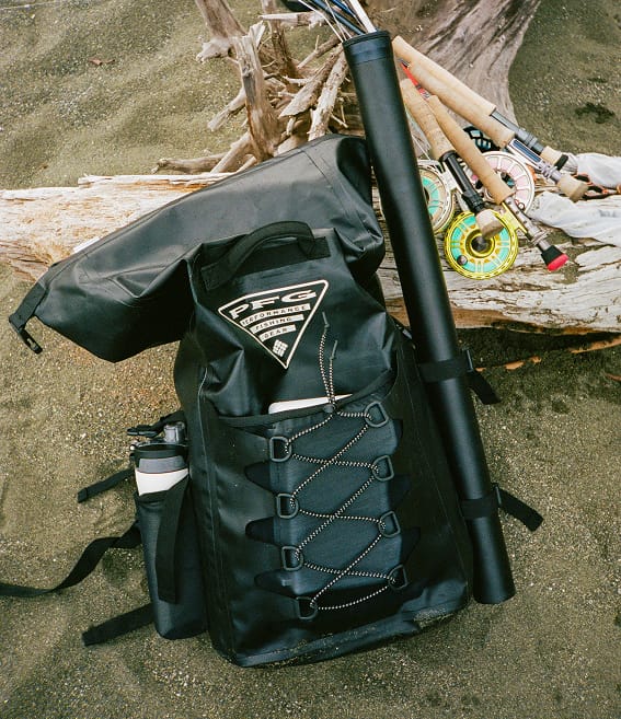 Close up of a PFG backpack on a sandy beach.