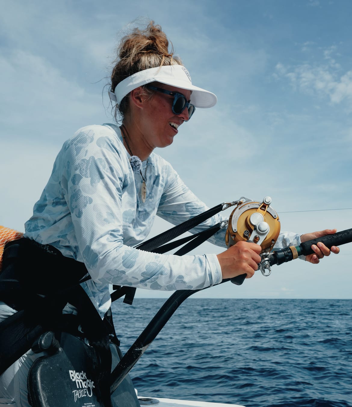 Bri Andrassy fishing from a boat.