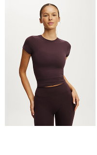 Woman wearing burgundy cropped t-shirt and matching pants