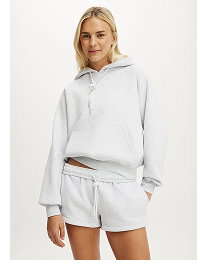Woman wearing light grey hoodie and matching shorts