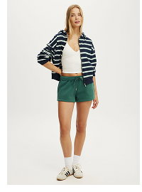 Woman wearing striped blazer and green shorts outfit