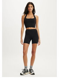 Black crop top and bike shorts two-piece set on model