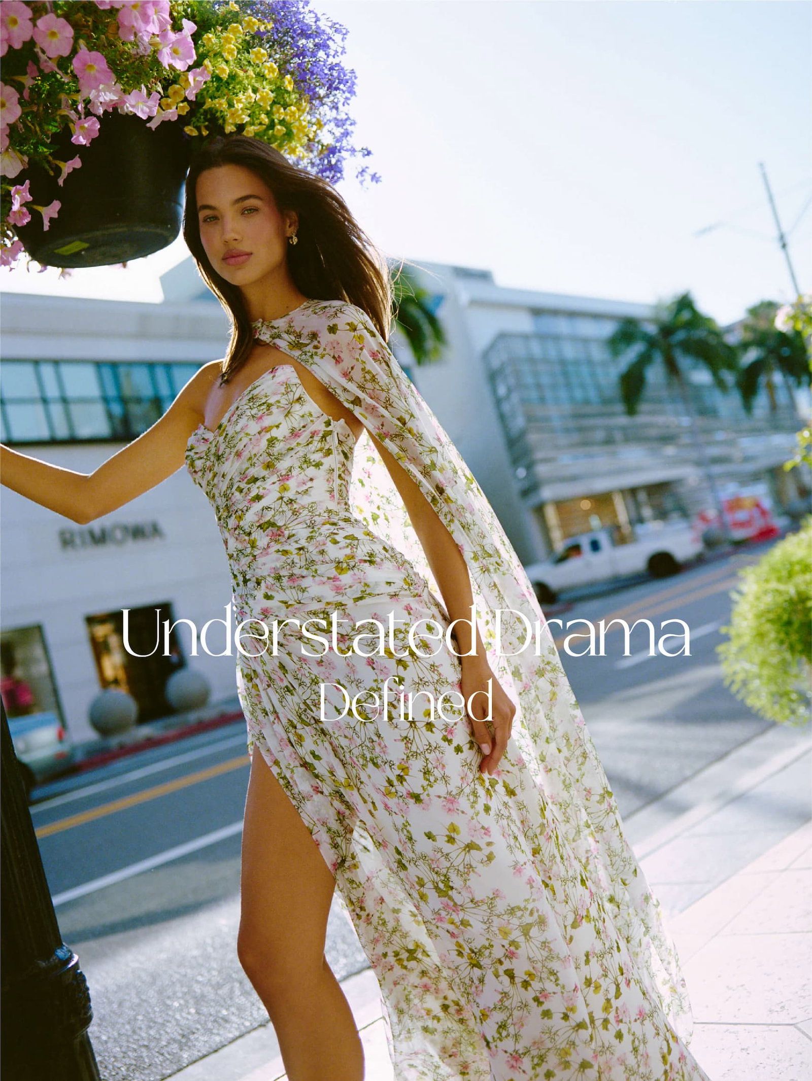 Model wearing ivy bloom printed chiffon gown with floor length cape