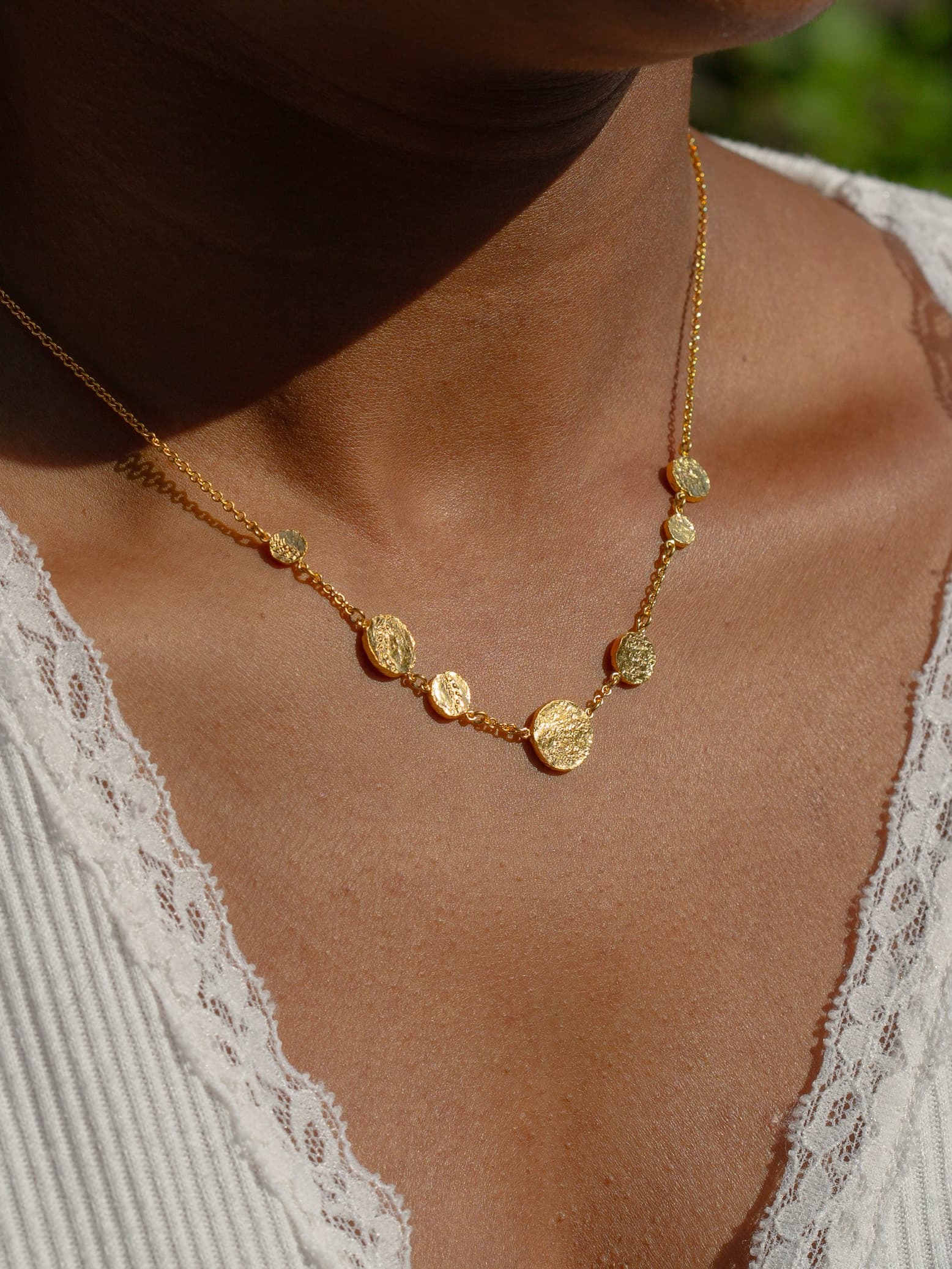 https://alexmonroe.com/products/imprinted-seed-disc-inline-station-necklace