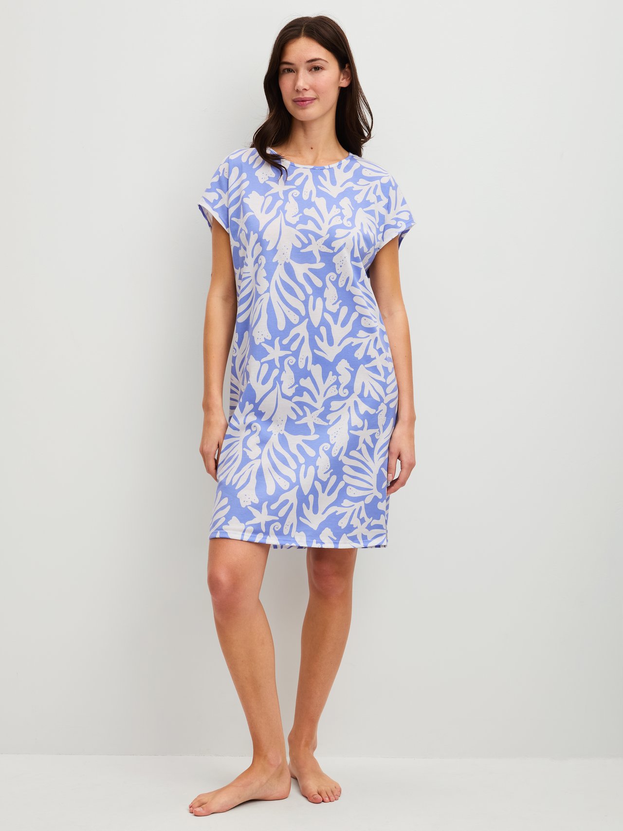 Women model is wearing Short-sleeved nightdress, length 95 cm made of 100% Cotton in Blue, Floral from the Cotton Special series by CALIDA, Front view
