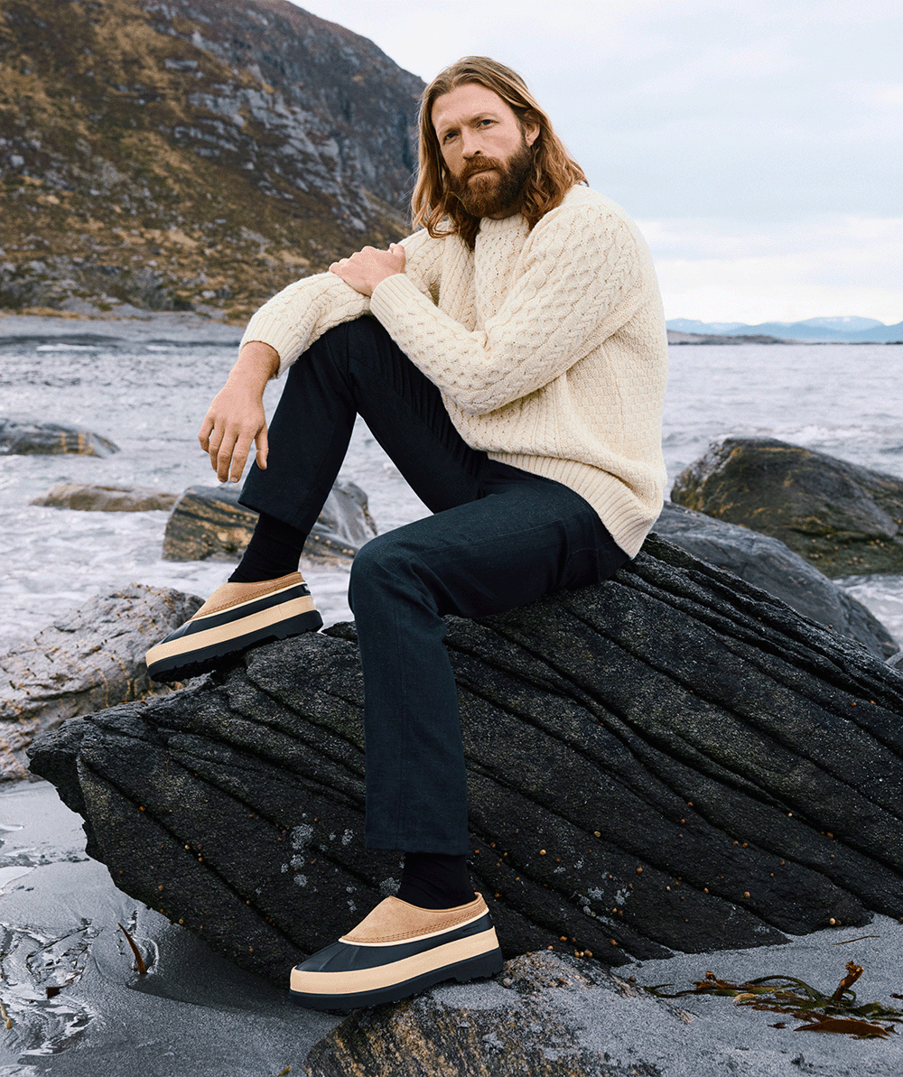 Man wearing Ambler™ Waterproof Men's Clog with Ocean in background 