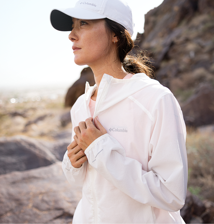 A woman wearing a white windbreaker