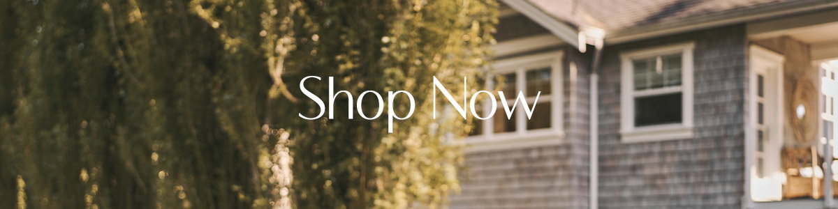 Tree-lined home exterior with text overlay: “Shop Now.”
