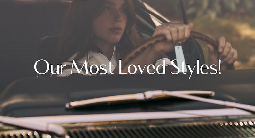 Model driving a vintage car wearing a striped rugby-style top. Text: “Our Most Loved Styles!”
